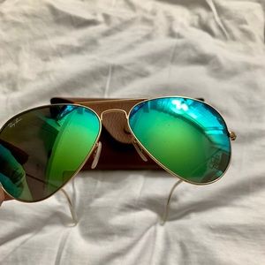 Ray Ban Sunglasses with green lenses.